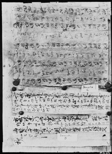 Black and white photograph of a manuscript written in a meaningless script resembling Brahmi.