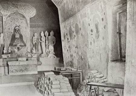Historical composite photograph of two Mogao caves, showing the statues at the back of Cave 16 and the hatch leaving to Cave 17, the Library Cave.