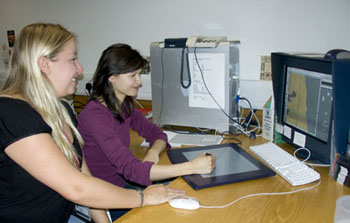 Two colleagues sitting at a computer.