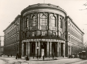 Grand nineteenth-century building on a street corner, historic sepia photograph.