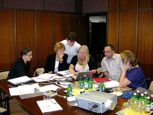 Colleagues in discussion, sitting around a table.