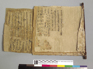 A rather tattered looking codex-form (butterfly-bound) manuscript in Chinese.