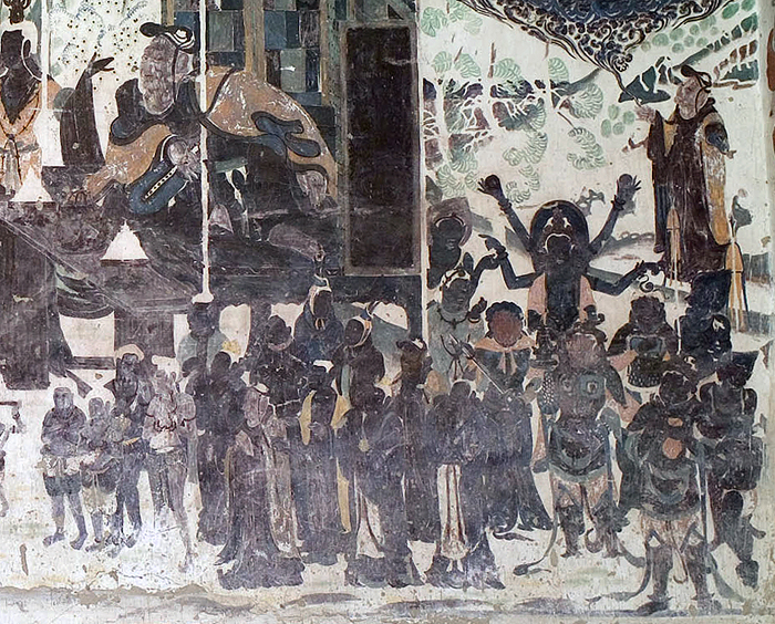 Mural of a crowd scene, with a large inset image of Vimalakīrti above it.