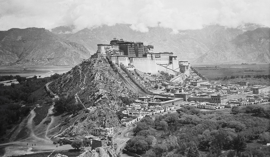 Palace and town complex built into a hillside. Historic black and white photograph.