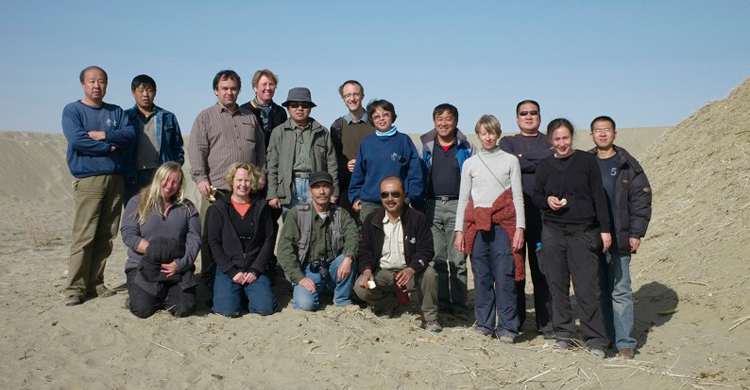 A group of people posed for a photograph in a desert landscape.