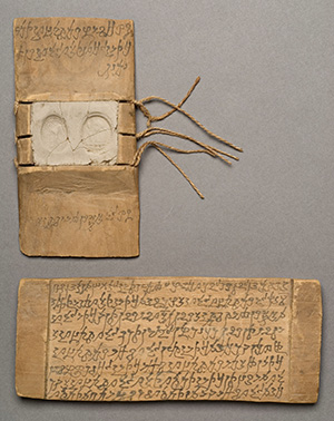 Wooden tablet with writing in Gāndhārī using Kharoṣṭhī script, and a section where parties to a legal agreement used thumb prints to ratify it.