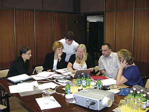Colleagues at a workshop, looking at digitised items. 