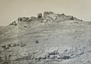 Ruins of a building on a bare hill, historic black and white photograph,