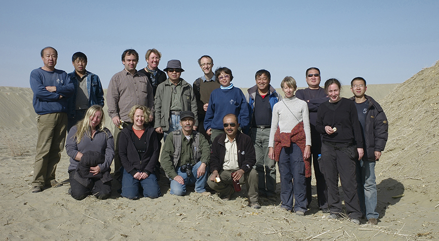 Colleagues on a field trip to sites in Xinjiang, posed in the desert.