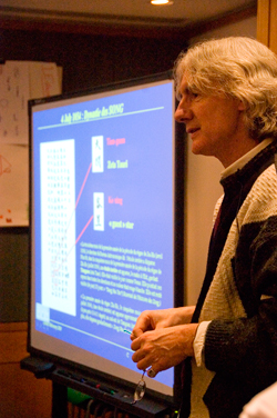 Jean-Marc Bonnet-Bidaud standing next to a projector screen while presenting on the Dunhuang star chart.