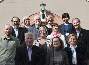 A group of symposium delegates, photographed outside. 