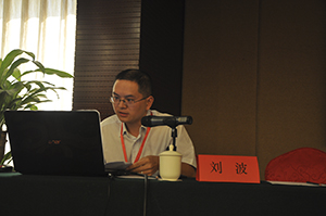 Liu Bo seated at a desk presenting a paper.