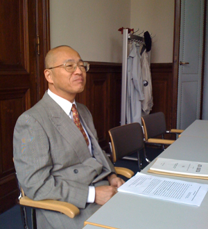 Takao Moriyasu seated at a desk.