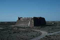 Modern colour photograph of a ruined watchtower in the desert. 