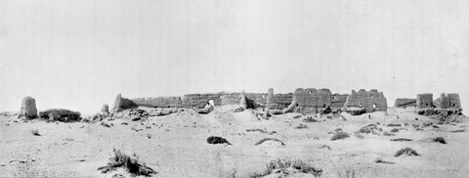 Historic black and white photograph of a ruined structure in the desert.