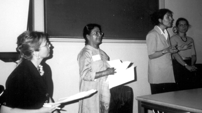 A black and white photograph of Dr Sarah Fraser, Dr Chhaya Haesner, Lilla-Russel-Smith and Dr Zsuzsanna Gulasci in a classroom giving a talk.