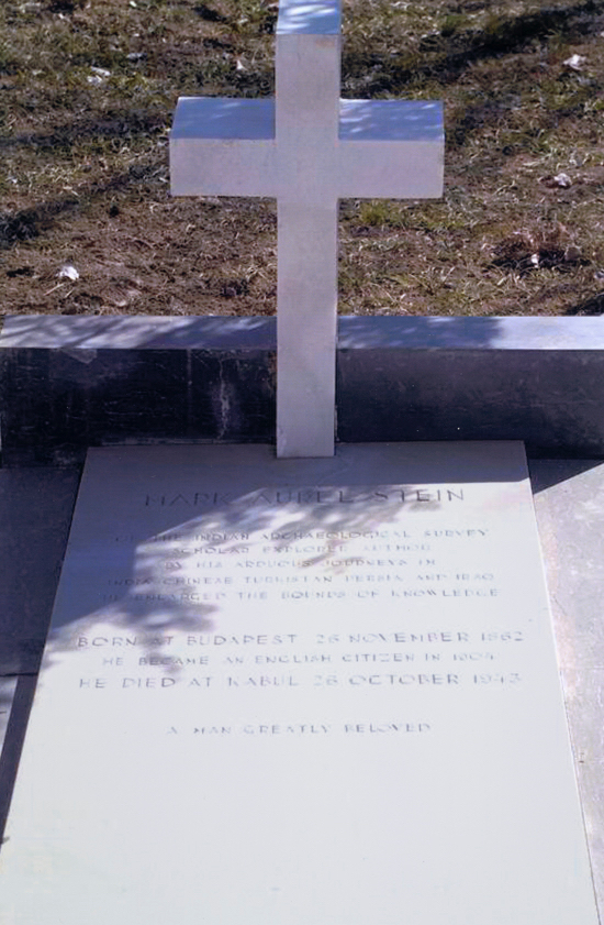 An engraved flat gravestone with cross sticking up. 